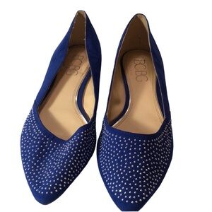 Woman’s blue silver studded flats cork sole